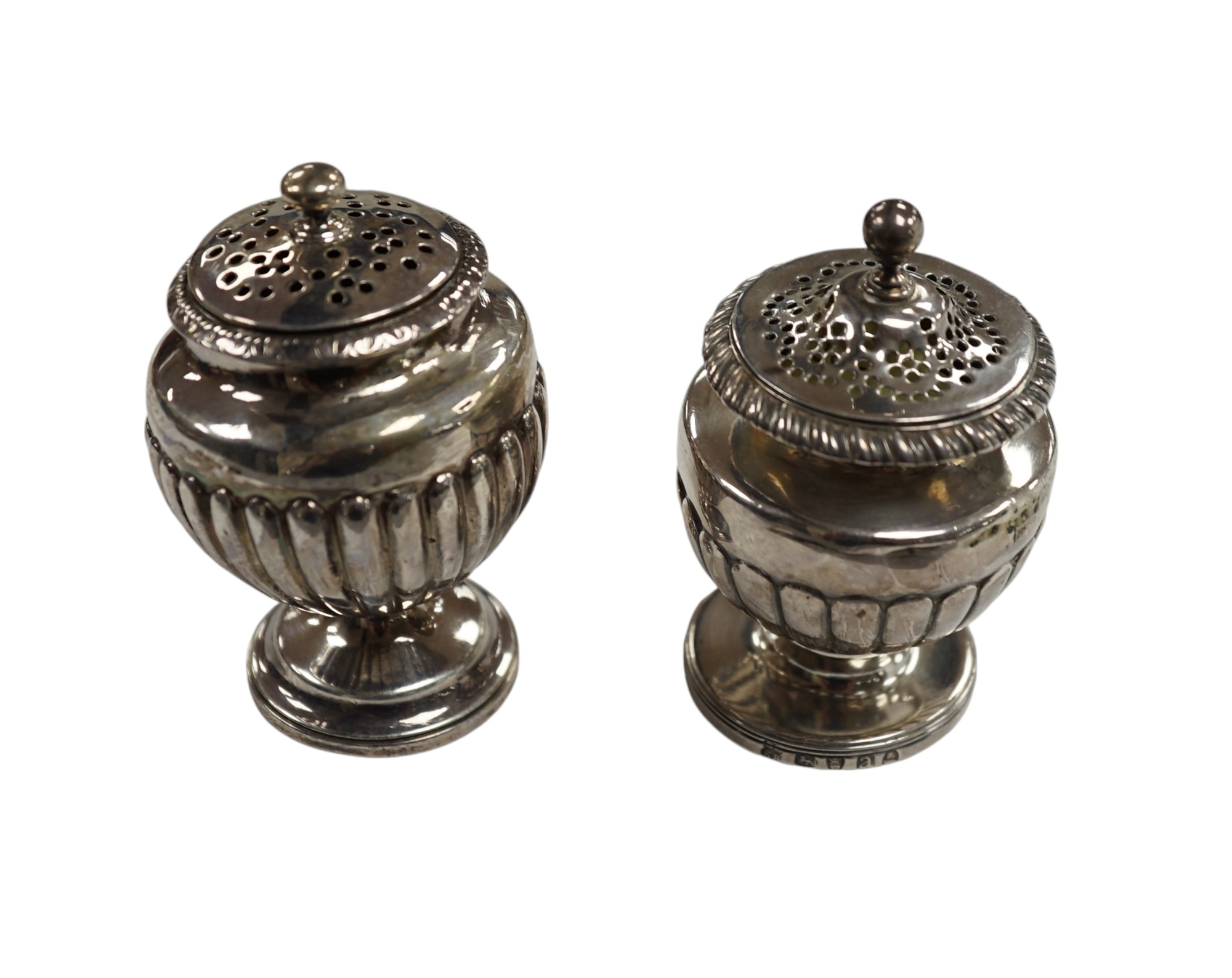 A George III silver pedestal pepper pot, by Eames & Barnard, London, 1816, 75mm and one other similar pepper pot, marks rubbed. Condition - poor